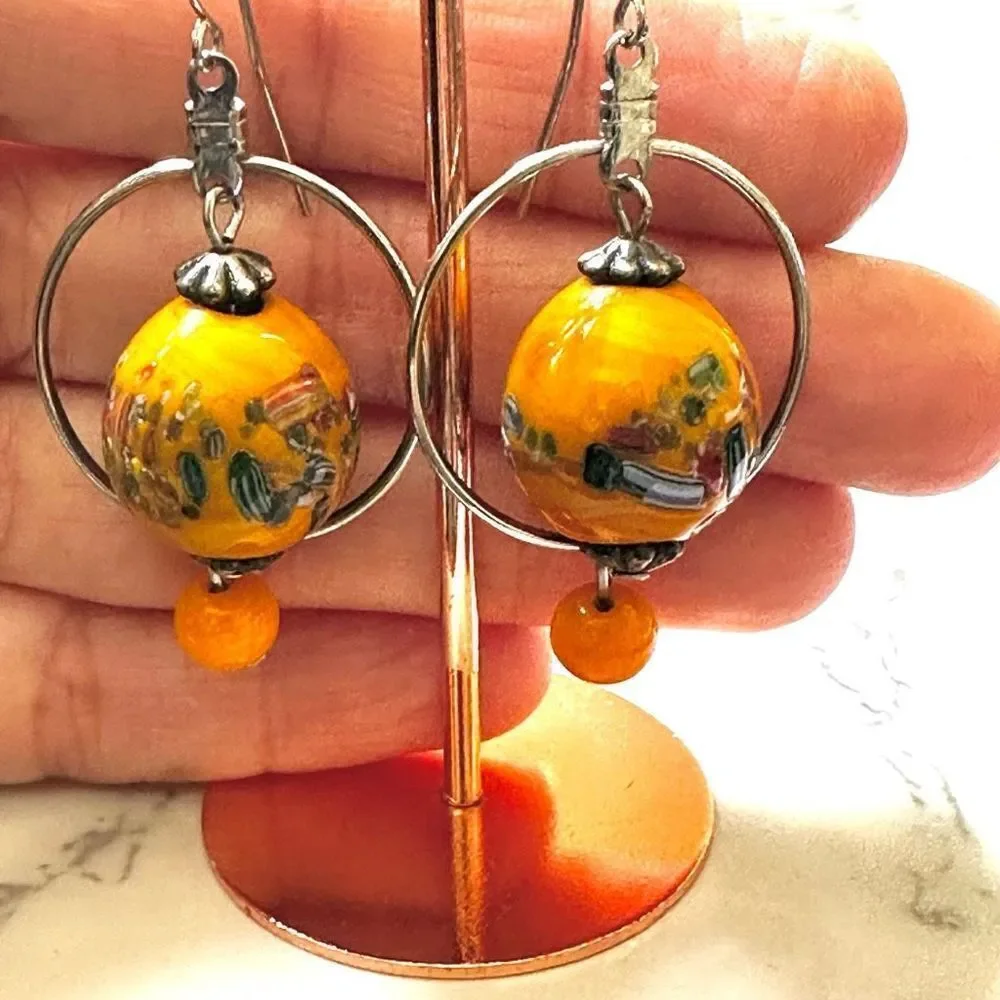 Silver tone orange beaded drop earrings